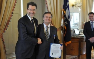 U.S. Ambassador to the Czech Republic, Norman Eisen, presents Dr. Losiewicz the Civilian Meritorious Service Medal in Prague.